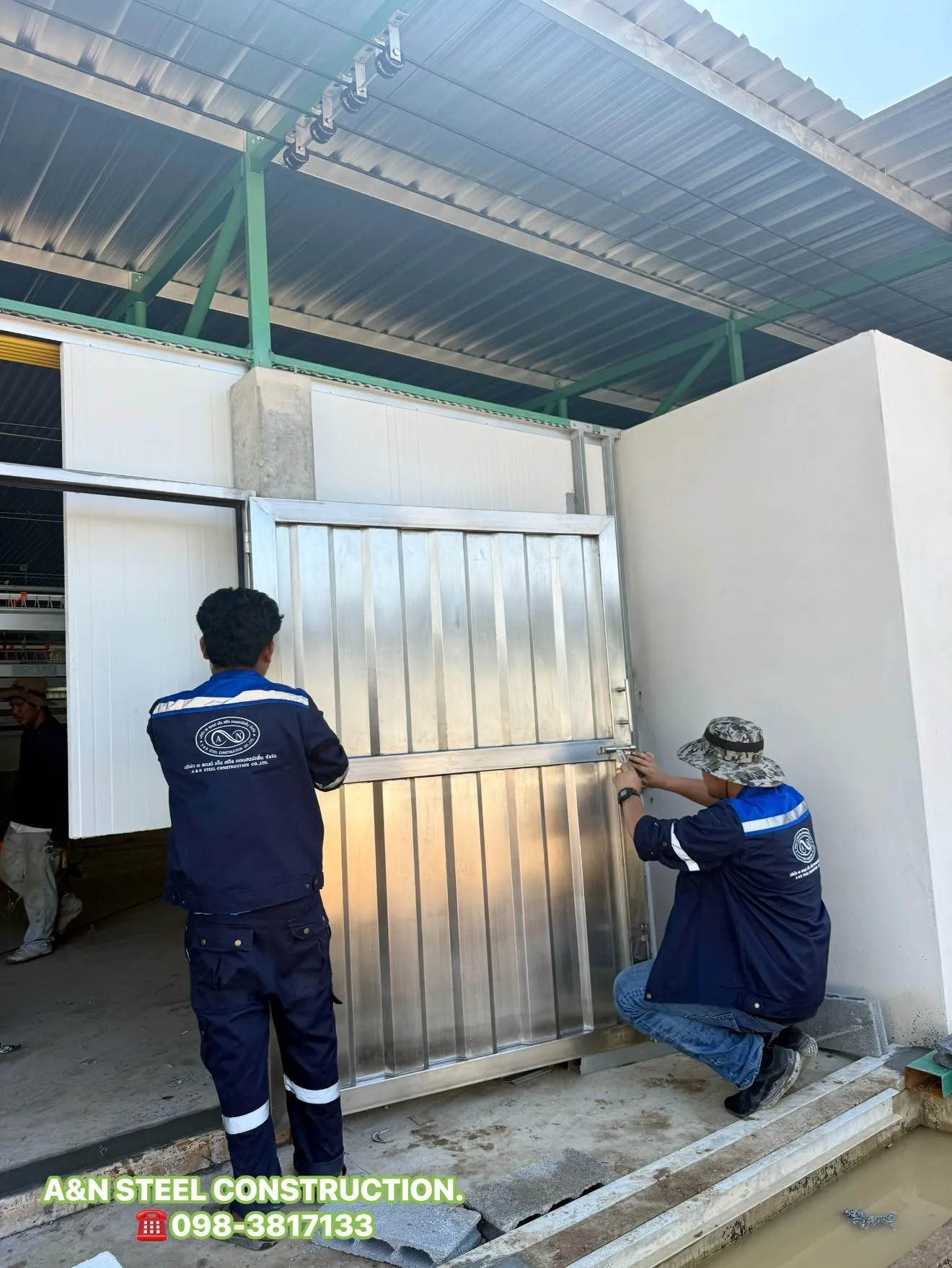 A & N technicians installing a stainless steel door on site